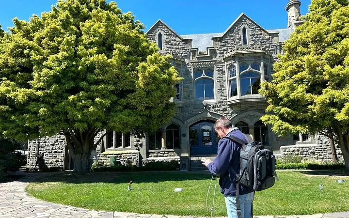 Christchurch small group tour visitor outside historic stone building.