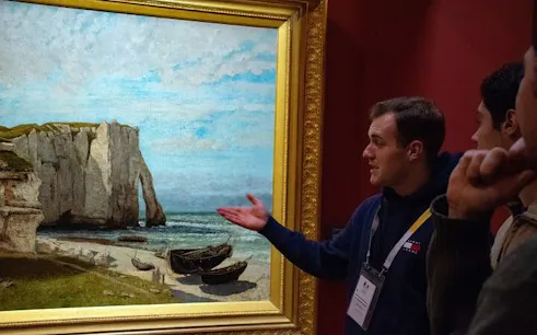 Tour guide explaining a painting at Musée d'Orsay during a small-group tour.