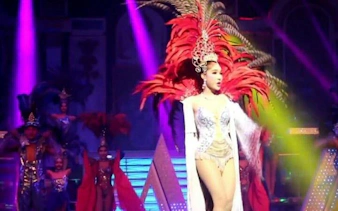Performer in vibrant costume on stage at Alcazar Cabaret Show, Pattaya.