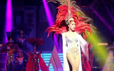 Performer in vibrant costume on stage at Alcazar Cabaret Show, Pattaya.