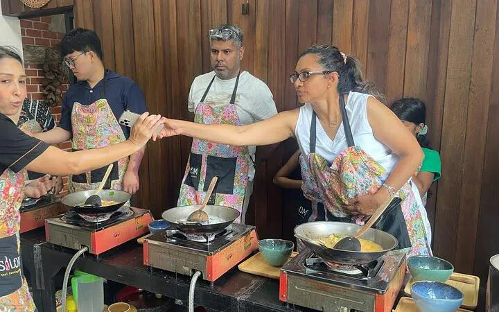 Participants cooking at Silom Thai Cooking School in Bangkok.