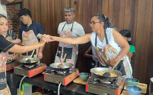 Participants cooking at Silom Thai Cooking School in Bangkok.