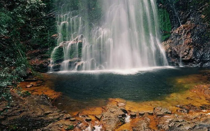 Silver Waterfall cascading into a rocky pool, Sapa Private Car Tour.