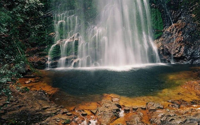 Silver Waterfall cascading into a rocky pool, Sapa Private Car Tour.