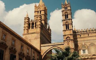 Palermo Cathedral towers under a blue sky on a self-guided walking tour.
