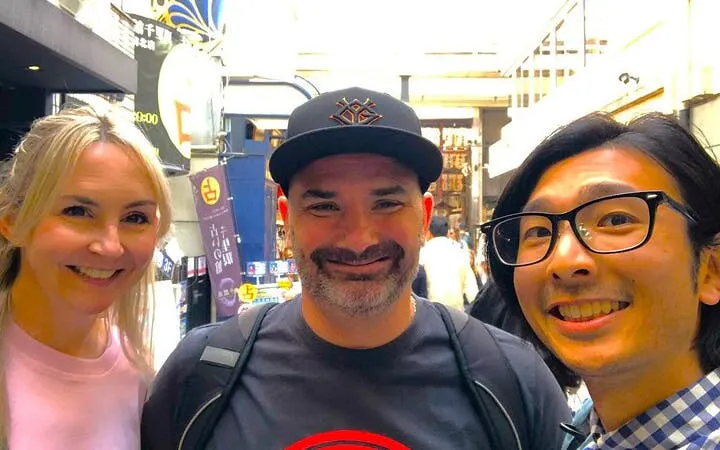 Tourists enjoying Nishiki Market in Kyoto during a private tasting tour.