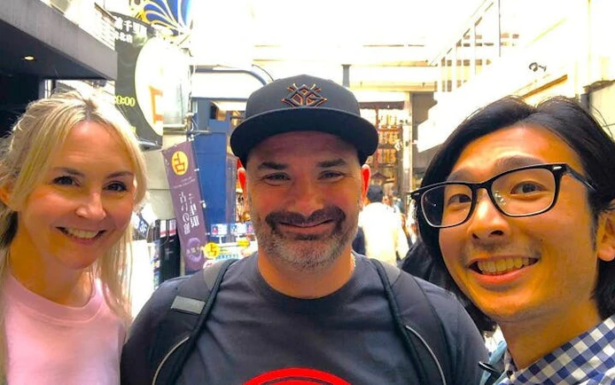 Tourists enjoying Nishiki Market in Kyoto during a private tasting tour.