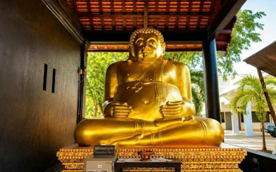 Golden Buddha statue at Wat Suan Dok, Chiang Mai, part of guided temple tour.