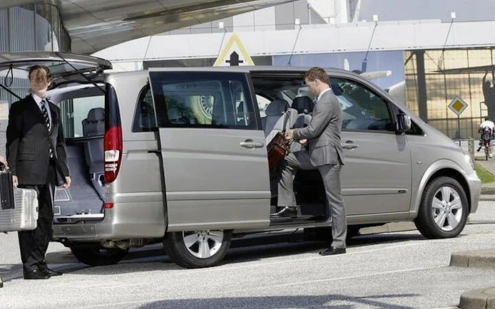 Private transfer service vehicle with driver and passenger, Taghazout to Marrakesh.