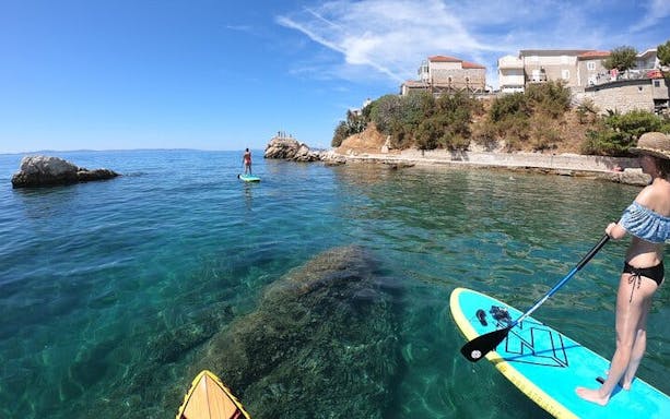 split stand-up paddleboarding tour across sea, river, and mountain landscapes-3