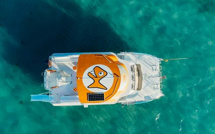 Catamaran on turquoise water, Punta Cana snorkeling cruise.