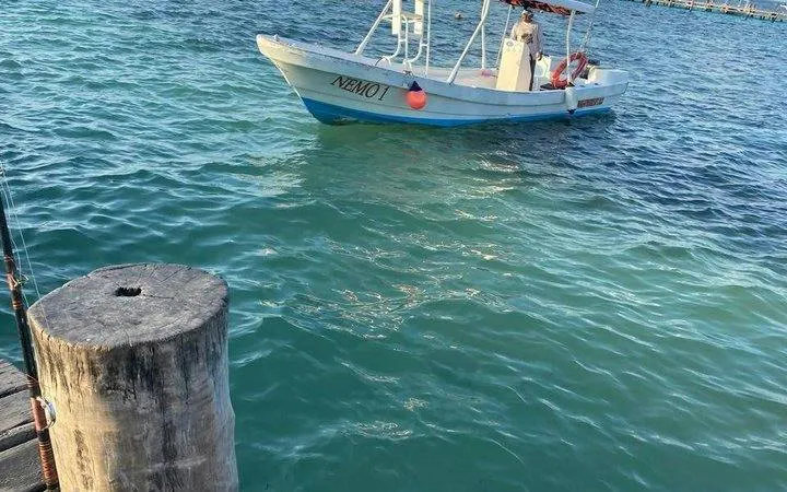 Boat on turquoise waters at Puerto Morelos National Reef Park, Riviera Maya.