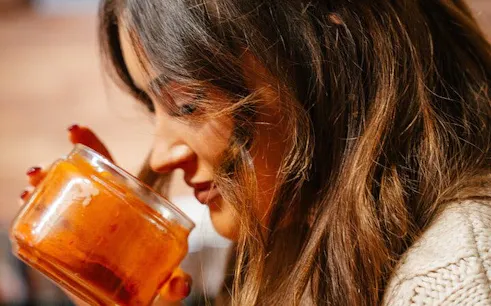 Woman smelling paprika during Hungarian cooking class in Budapest.