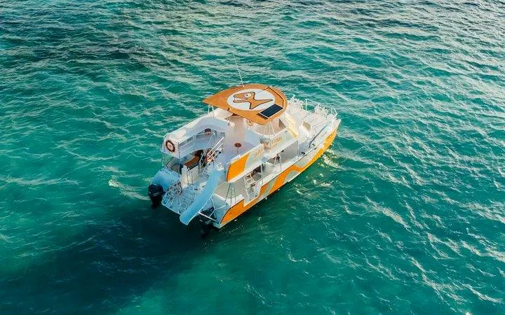 Snorkeling cruise boat on turquoise waters, Punta Cana natural reserve.