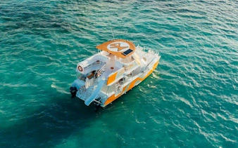 Snorkeling cruise boat on turquoise waters, Punta Cana natural reserve.