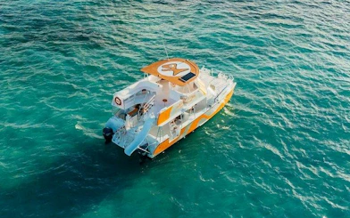 Snorkeling cruise boat on turquoise waters, Punta Cana natural reserve.