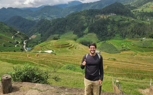 Mu Cang Chai terraced rice fields with a visitor on a trekking tour.
