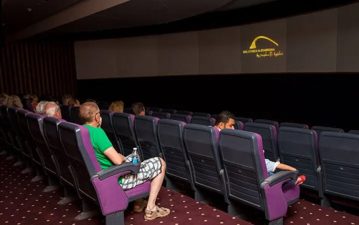 Visitors seated in a theater watching a Culturama presentation in Sharm El Sheikh.