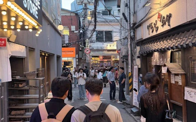 Seoul street with people exploring Chimaek night food spots, featuring fried chicken and beer venues.