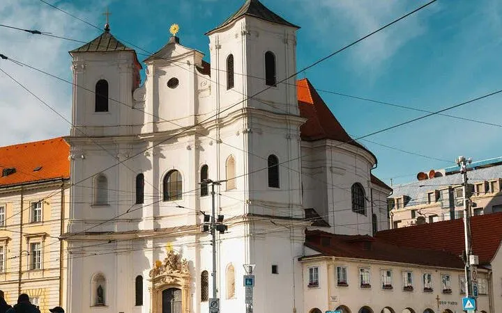 Baroque church facade in Bratislava on a sunny day, part of a self-guided walking tour.