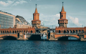 Oberbaum Bridge over the Spree River in Berlin, featured in a self-guided walking tour app.