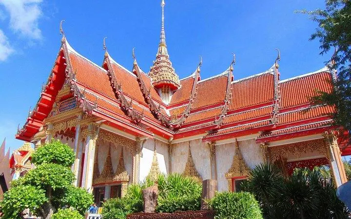 Wat Chalong temple with ornate red roof and spires, Phuket City tour.