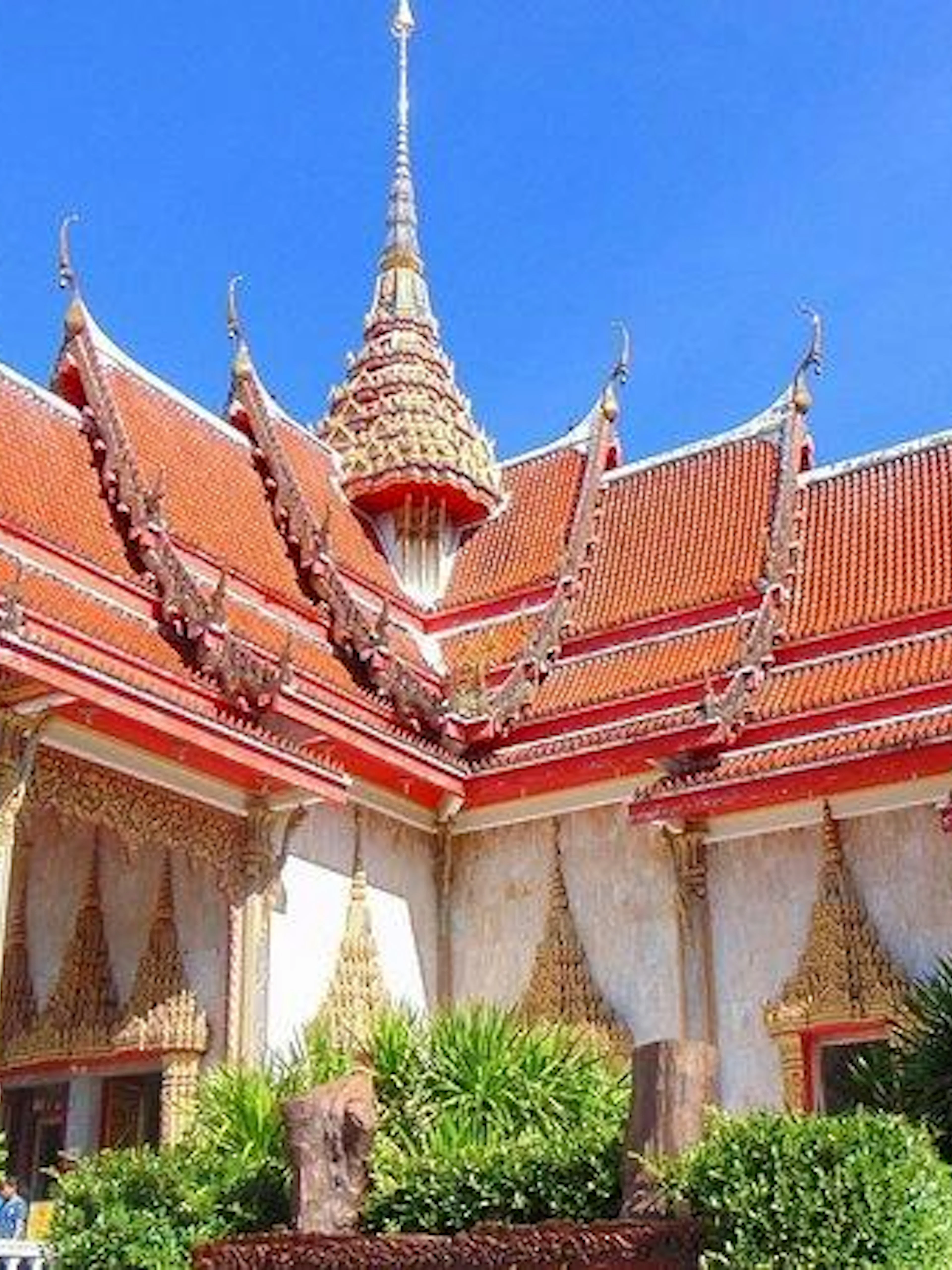 Wat Chalong temple with ornate red roof and spires, Phuket City tour.