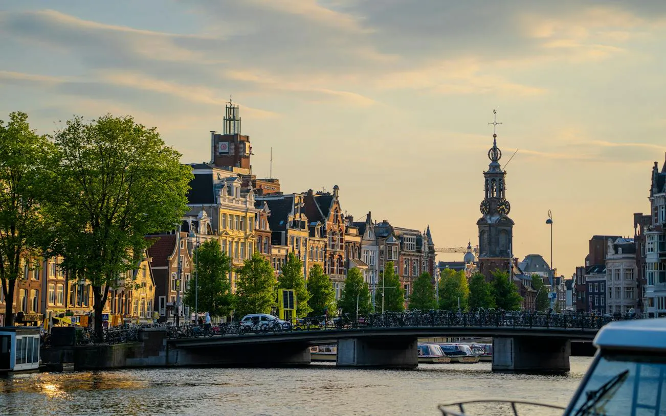 Amsterdam Canal Ring with historic buildings and bridge during self-guided audio walking tour.