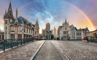 Ghent cityscape with historic buildings and rainbow on a self-guided walking tour route.