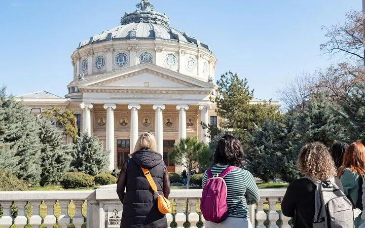 Tourists viewing the Romanian Athenaeum during Bucharest Old Town walking tour.