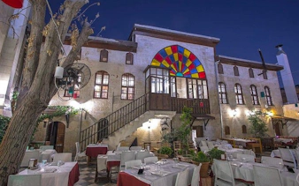 Outdoor dining area at a traditional Turkish restaurant in Eastern Turkey with colorful stained glass.
