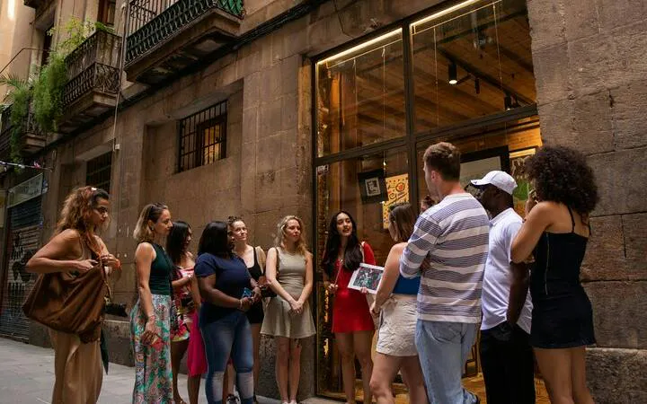 Group of tourists on a walking tour in Barcelona's Gothic Quarter.