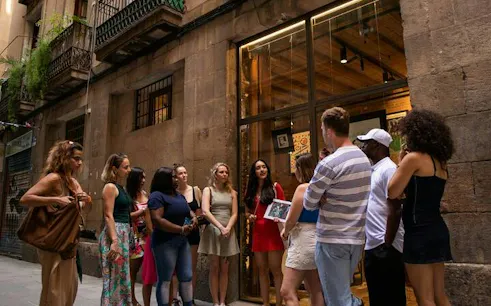 Group of tourists on a walking tour in Barcelona's Gothic Quarter.