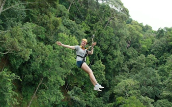 Chiang Mai jungle zipline adventure through lush forest canopy.