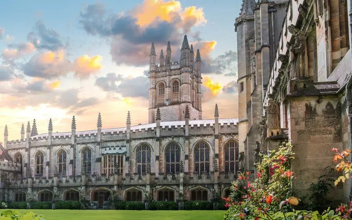 Oxford college courtyard with historic architecture during sunset.