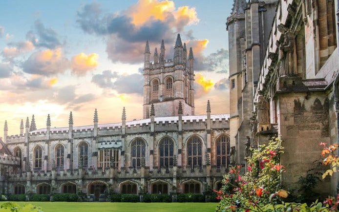Oxford college courtyard with historic architecture during sunset.