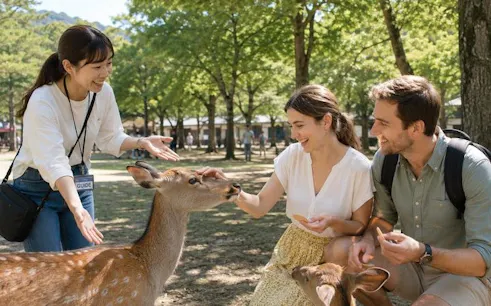 Visitors interacting with deer in Nara Park during a guided tour.