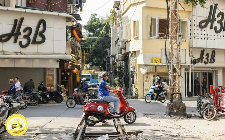 Vespa rider on Hanoi street near Bat Trang Ceramic Village tour route.