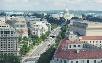 Aerial view of Washington DC with the Capitol Building in the distance.