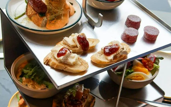 Traditional Norwegian meal with open-faced sandwiches and assorted dishes on a tiered tray, Oslo.