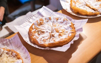 Hungarian lángos with sour cream served on a Budapest food tour.