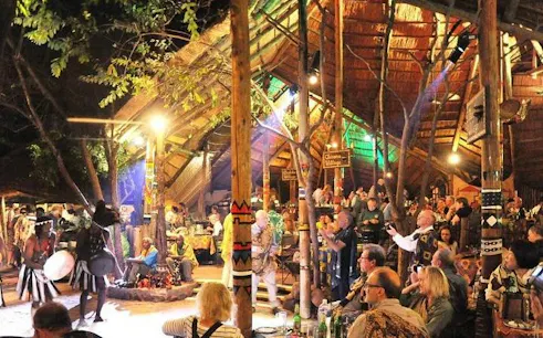 Traditional dance performance at a cultural village during the Victoria Falls Full Day Experience.