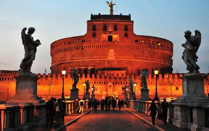 Castel Sant'Angelo at sunset with statues on Ponte Sant'Angelo, Rome.