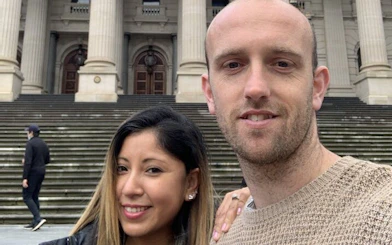 Couple in front of Melbourne's Parliament House during self-guided city exploration game.
