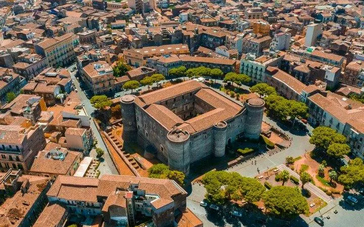 Aerial view of Castello Ursino in Catania, Italy, surrounded by cityscape.