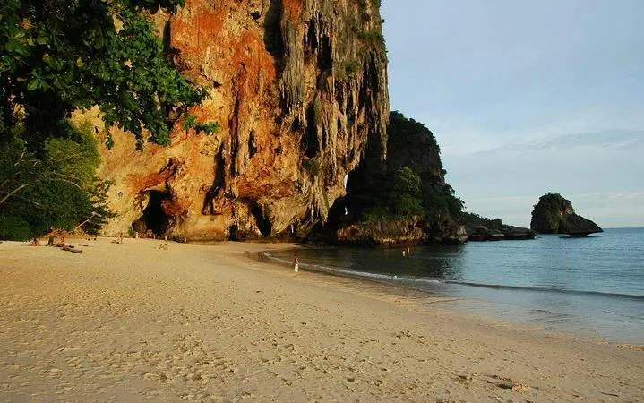 Rock climbers on limestone cliffs at Railay Beach, Krabi, Thailand.