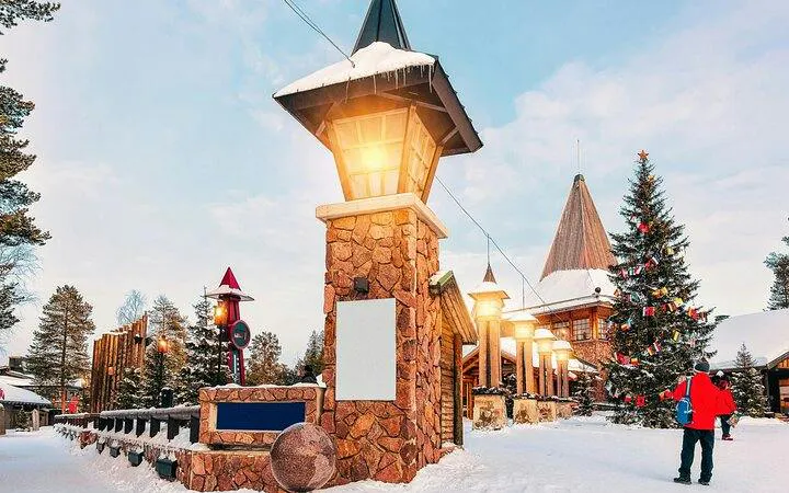 Santa Claus Village entrance with festive lights and snow, Rovaniemi.