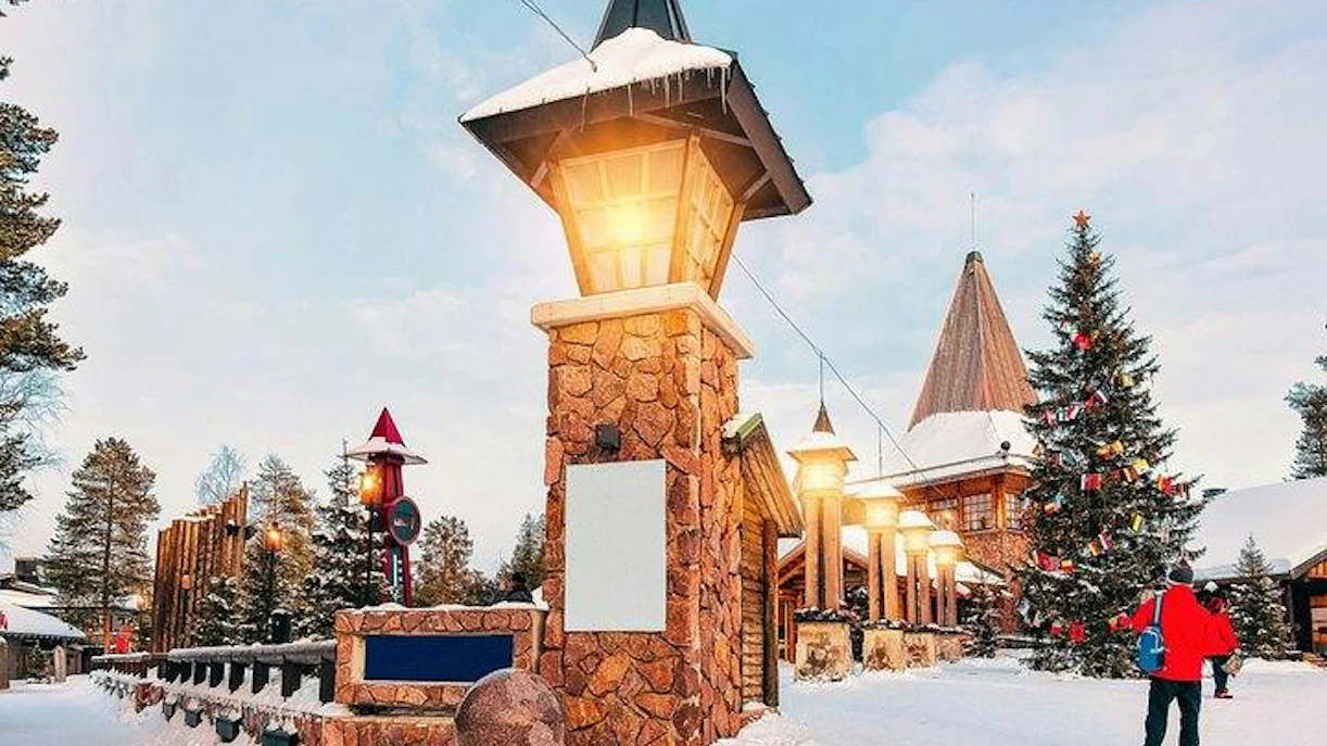 Santa Claus Village entrance with festive lights and snow, Rovaniemi.
