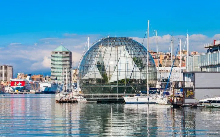 Genoa harbor with glass biosphere and boats, featured in self-guided walking tour app.