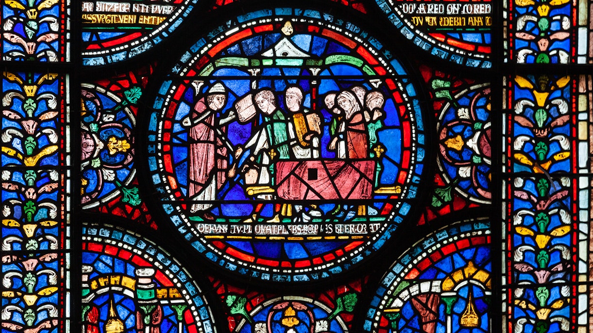Canterbury Cathedral exterior with tourists exploring the historic architecture.